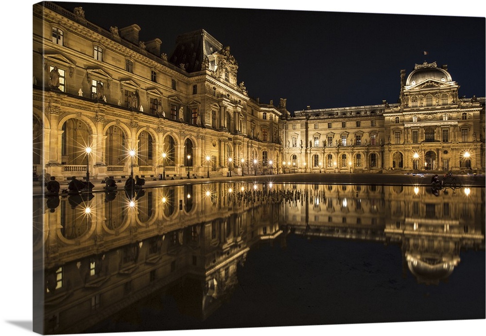The Louvre Museum reflected in the waters of the fountain.