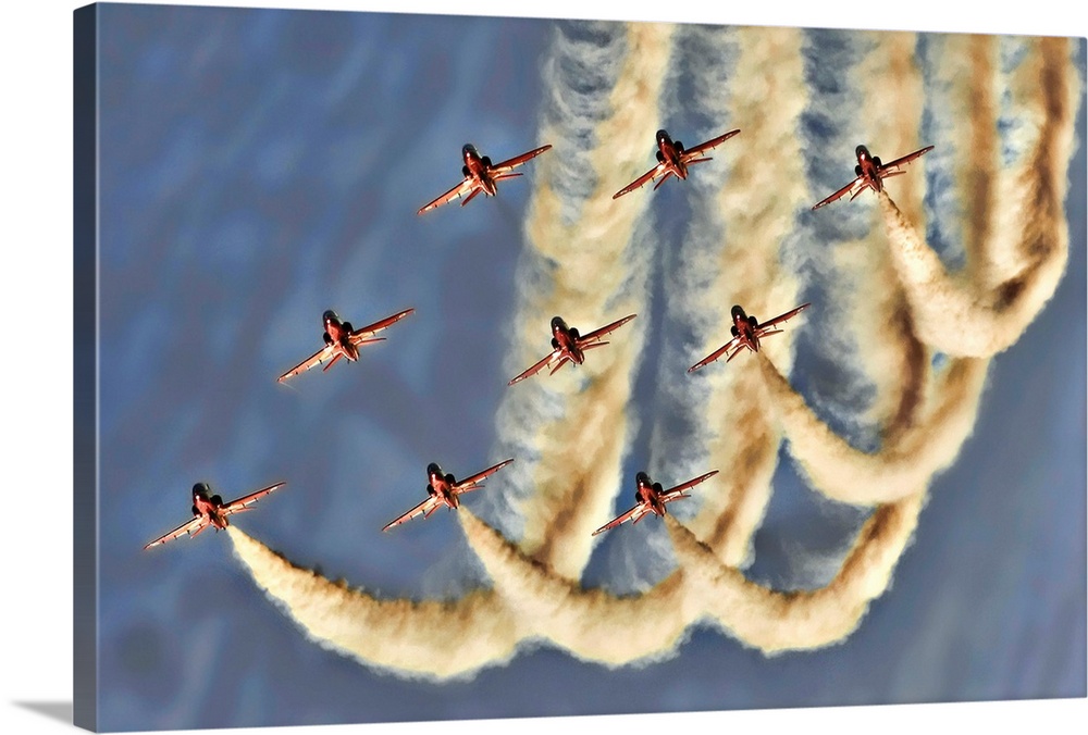 Nine jets flying in formation leaving trails in the sky.