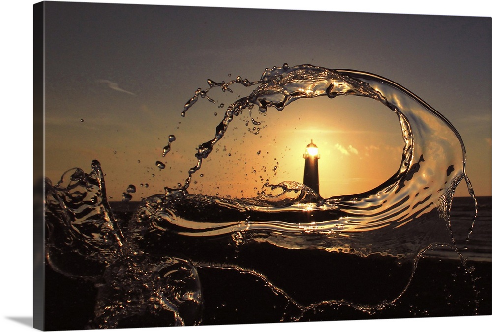 A splash of water frames Point of Ayr Lighthouse at sunset, Talacre, Wales.