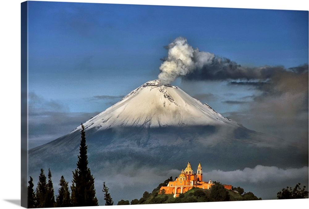 Popocatepetl, snowy and smoking with Choluula church in the foreground.