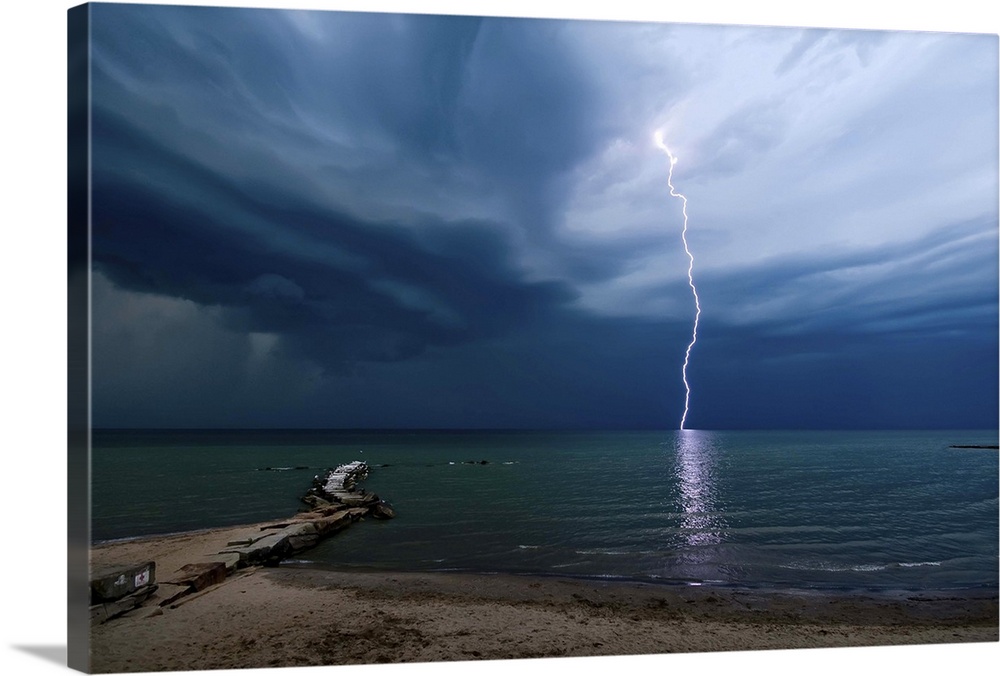 Photograph of a lightning strike over water.