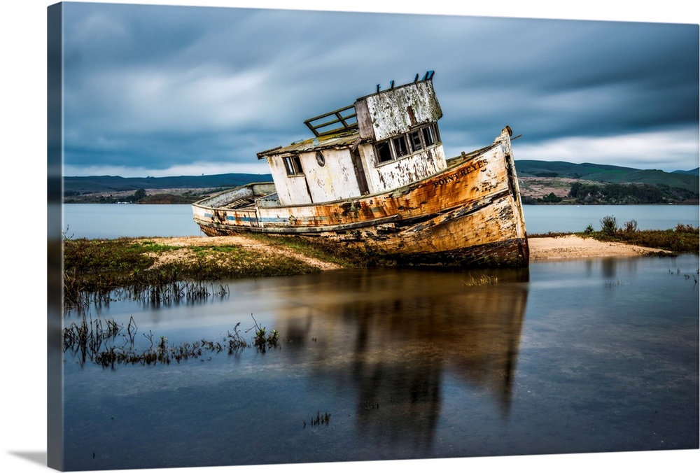 Abandoned and ruined ship beached in shallow water at Inverness, California.