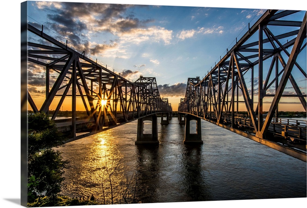 Light from the setting sun on the Natchez Bridges over the Mississippi River.
