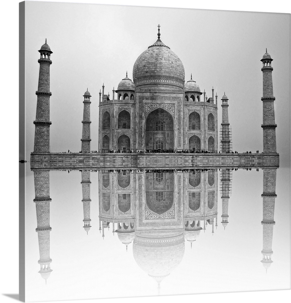Black and white photo of the Taj Mahal reflected in the water below.