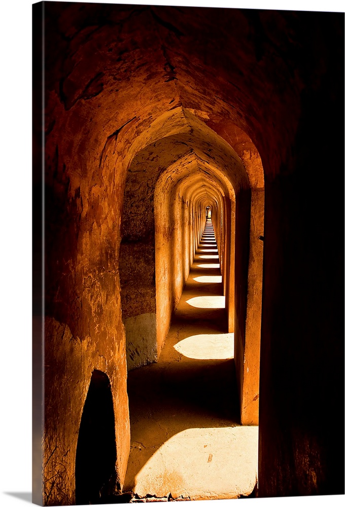 An arched hallway with amber color in Lucknow, India.