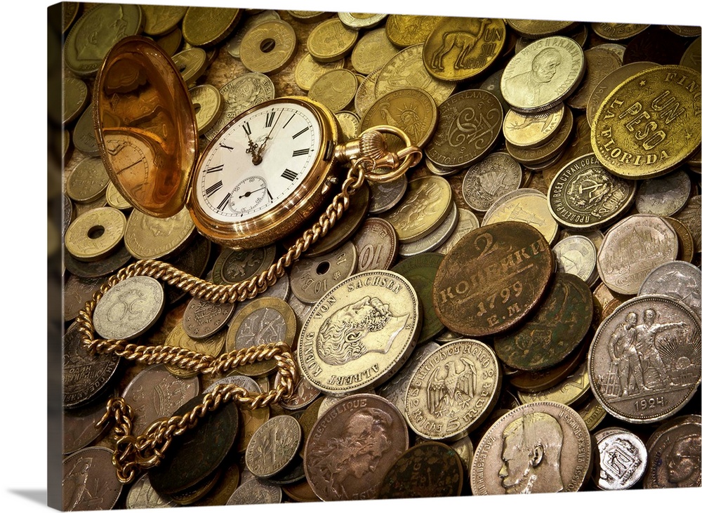 A collection of coins with a gold pocketwatch.