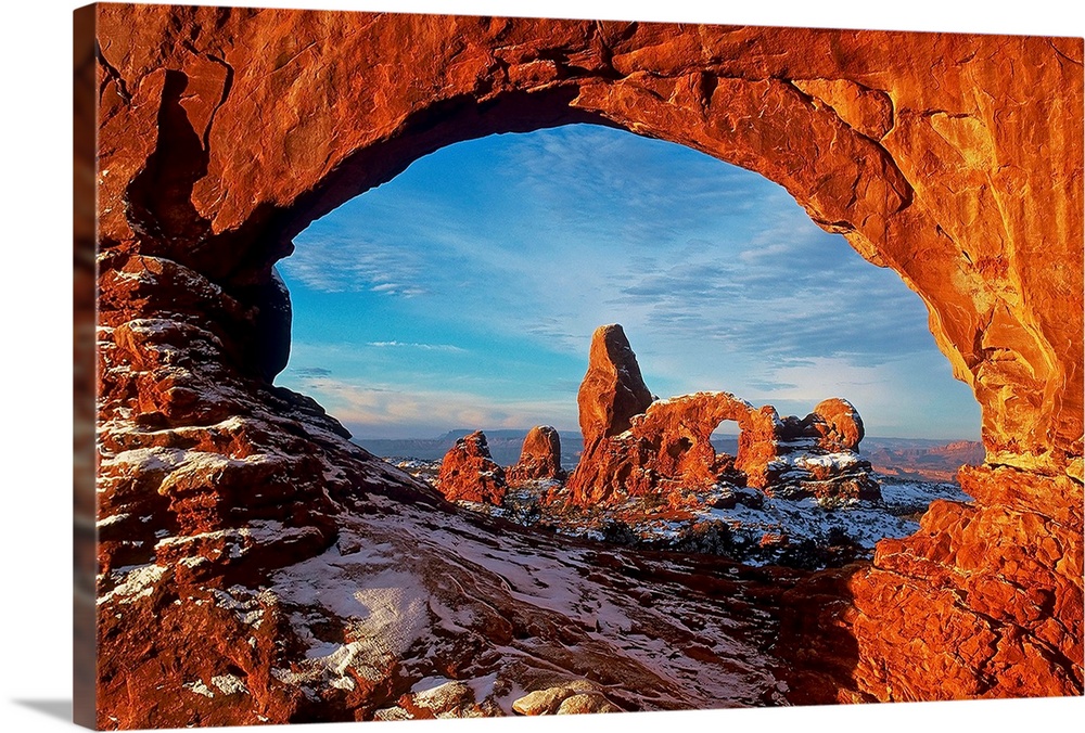 Turret Arch stands as an anomaly in the petrified dune field as seen through the North Window Arch in Winter, Arches Natio...