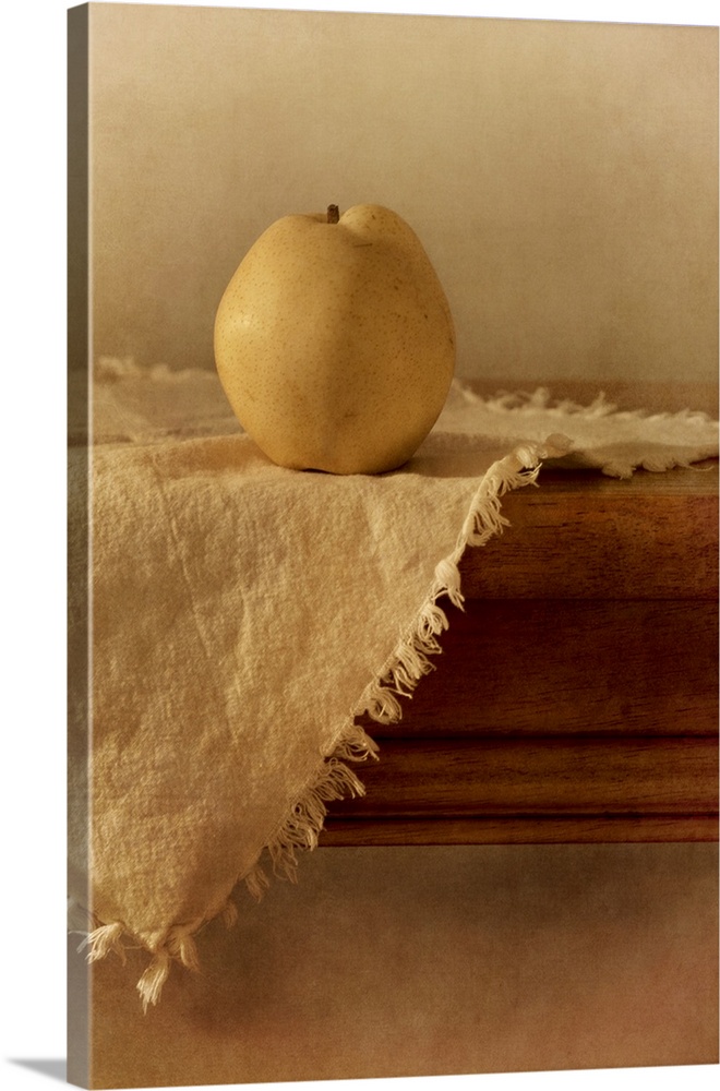 A single apple pear on a wooden table