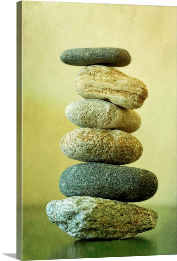 Large vertical piece showing stones that have been stacked on top of each other that decrease in size from bottom to top.