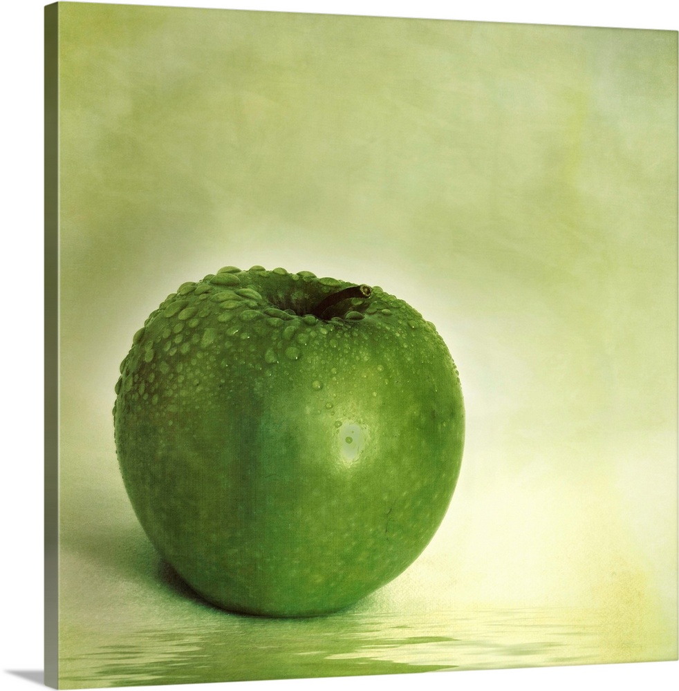 Green apple with water drops and reflection in the water