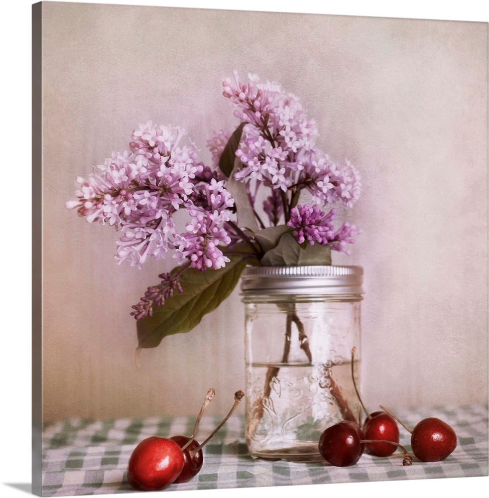 A still life, with lilac blossoms and red cherries