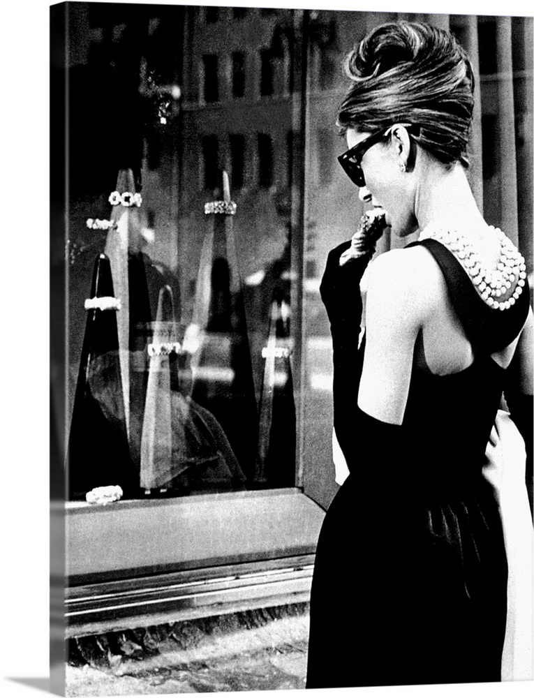 Big photograph showcases a famous Hollywood actress as she stares through an outdoor display case of jewelry.  This Britis...