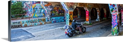 A motorcyclist enters the graffiti-covered Krog Street Tunnel in Atlanta, Georgia