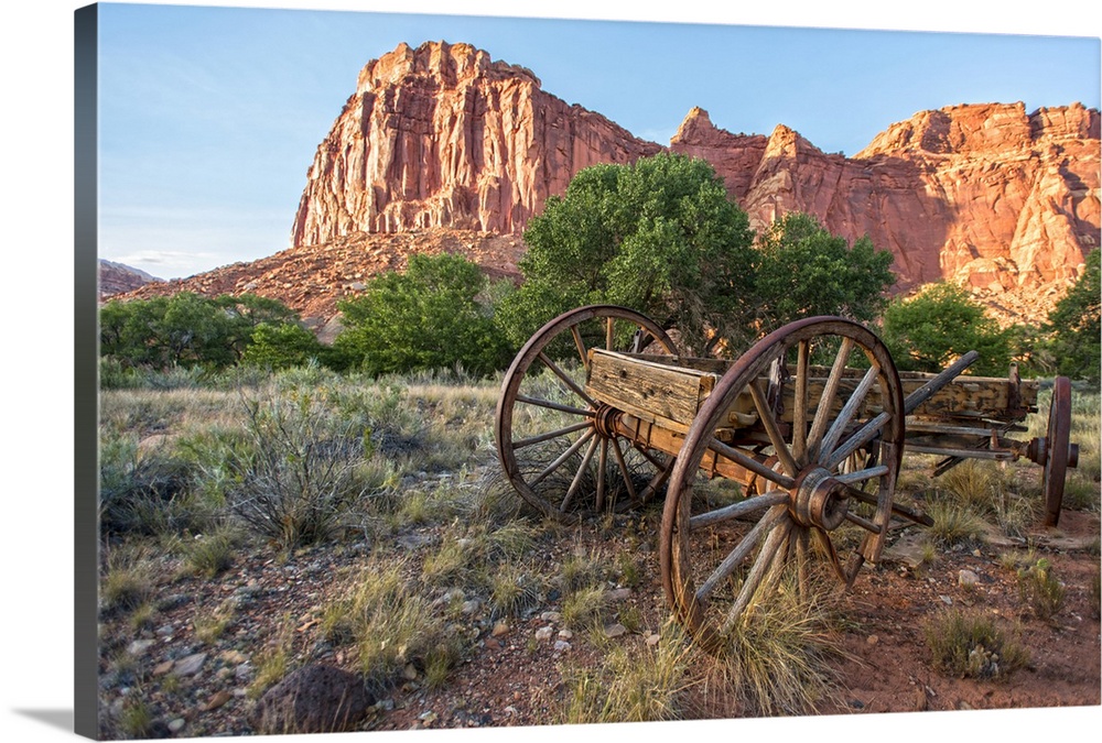 An antique wagon under Fruita's rock formations in Capitol Reef National Park, Utah.