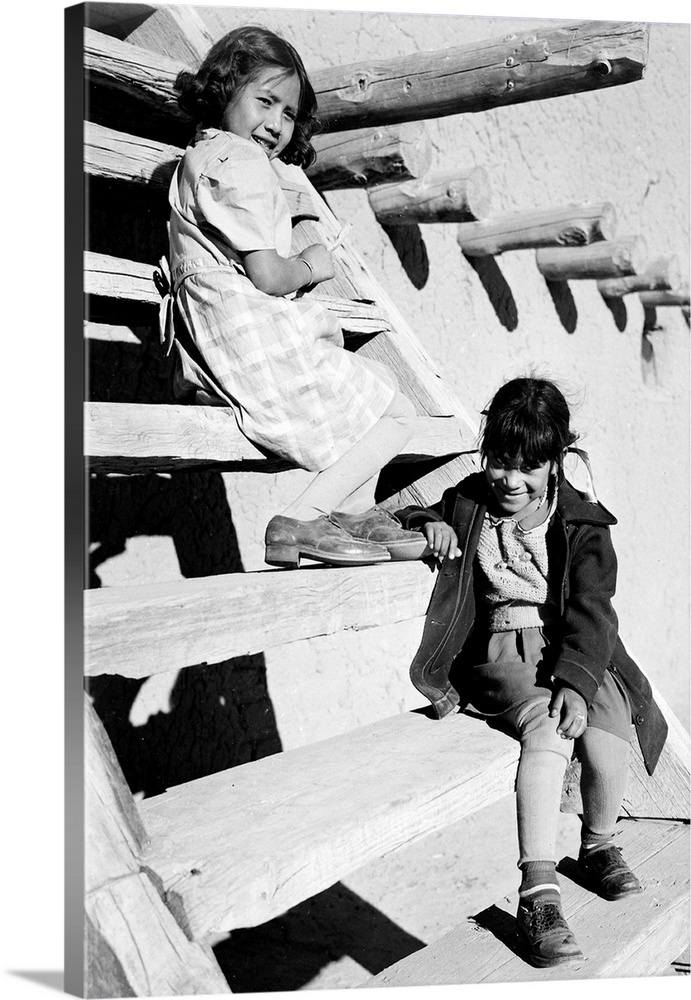 At San Ildefonso Pueblo, New Mexico, 1942, two young girls sitting on steps.