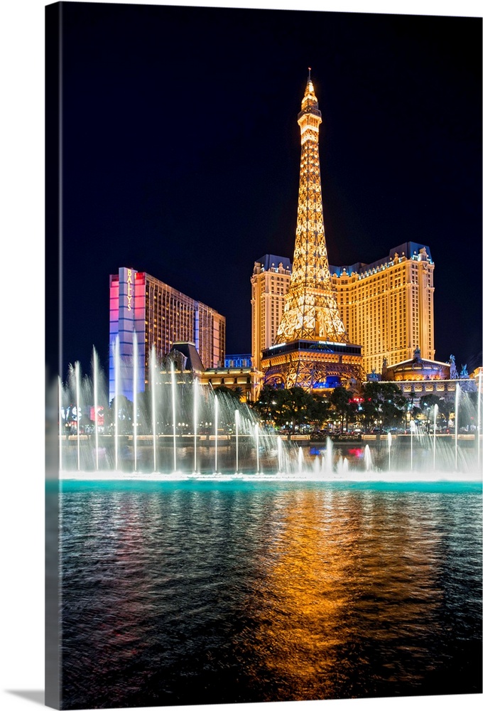 Photograph of the Bellagio Water Show outside of the Bellagio, Ballys, and the Eiffel Tower at night in Las Vegas, NV.