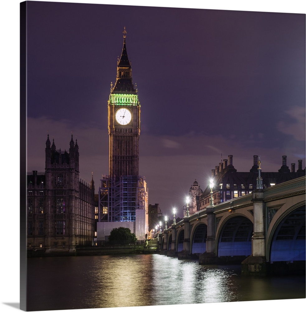 Square photograph of Big Ben lit up at dusk with the Westminster Bridge and River Thames in the foreground.