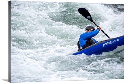 Blue Kayaker paddling through Whitewater Rapids - II