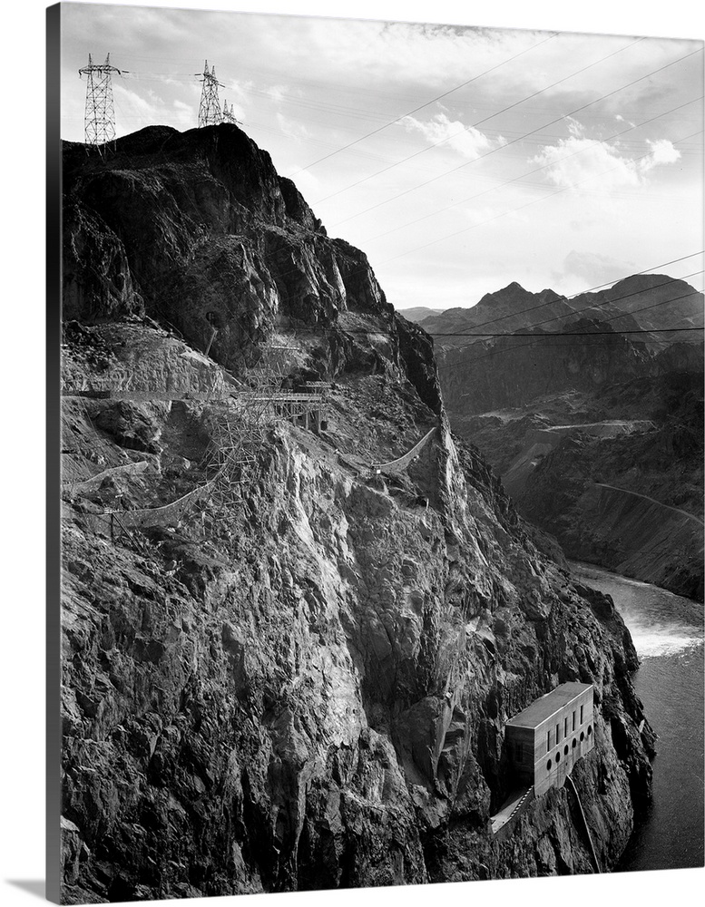 Boulder Dam, 1941, vertical of side of cliff with transmission lines above, river to left.