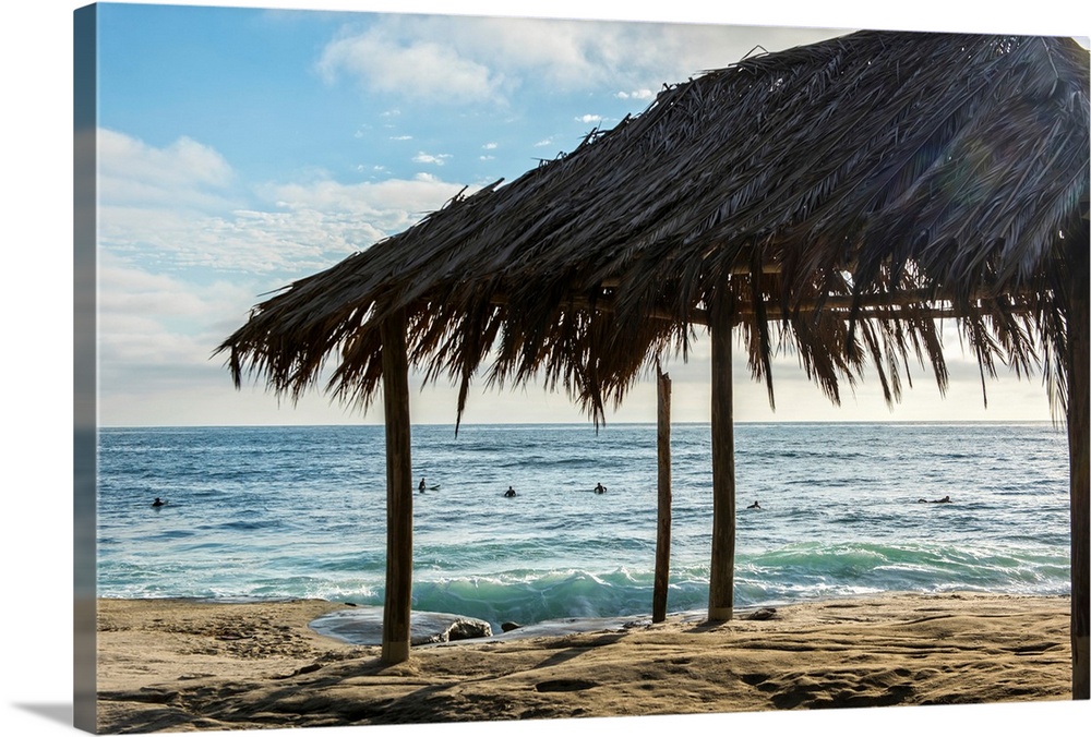 Photograph of a cabana made with natural materials on the shore of Windansea Beach, San Diego on a beautiful day.
