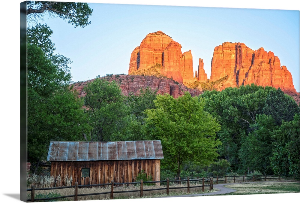 Landscape photograph of Cathedral Rock with a rustic wooden structure in the foreground.
