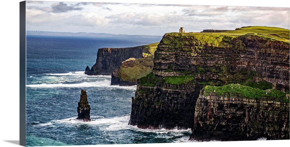 Panoramic photograph of the Cliffs of Moher with O'Brien's Tower seen in the distance, marking the highest point of the Cl...