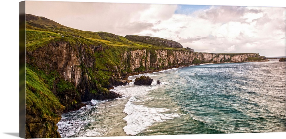 Panoramic photograph of the picturesque Cliffs of Moher with a cloudy sky above, located at the southwestern edge of the B...