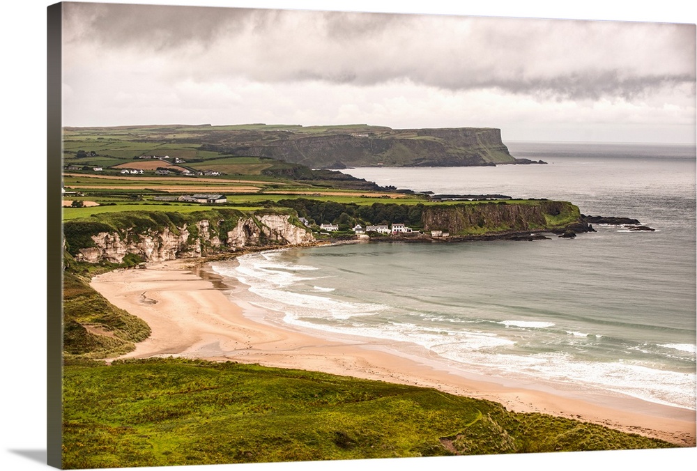 Landscape photograph of an Irish coastline with dramatic clouds above, County Antrim, Ireland.