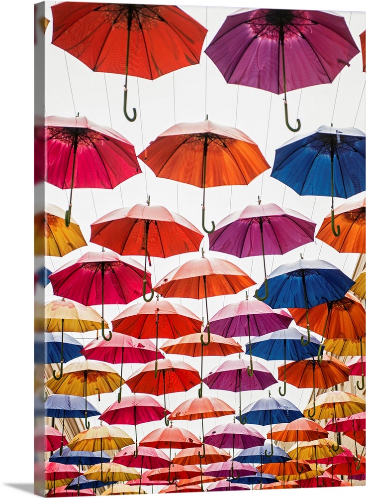 Vertical photograph of the colorful umbrellas hanging in Southgate Shopping Centre in Bath, England, UK.