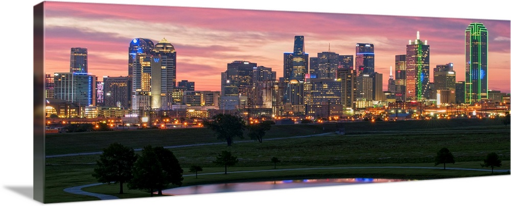 A horizontal image of the Dallas, Texas city skyline with a brilliant sunset.