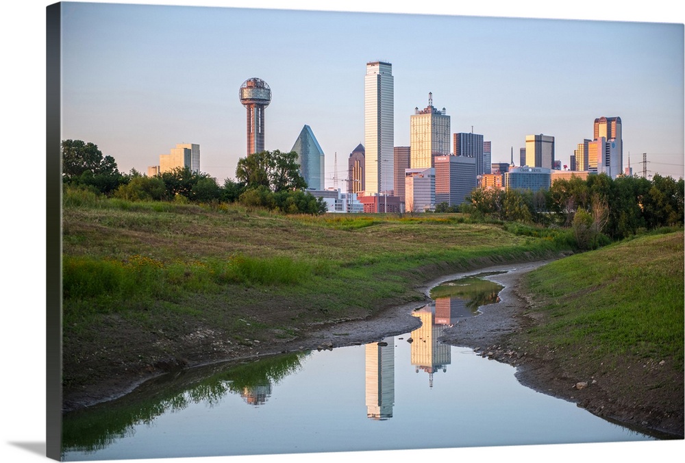 A creek in the foreground of the Dallas Texas skyline.
