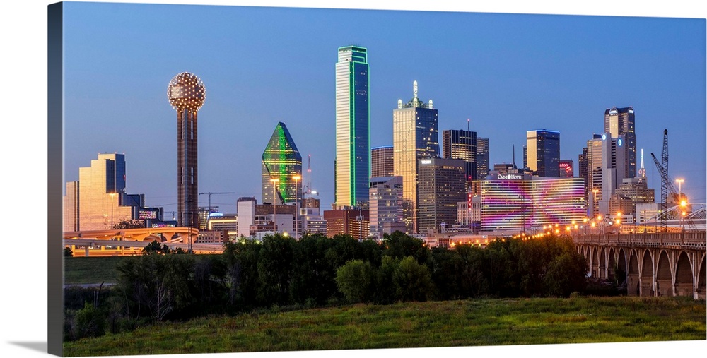 A horizontal image of  the Dallas, Texas city skyline at sunset.
