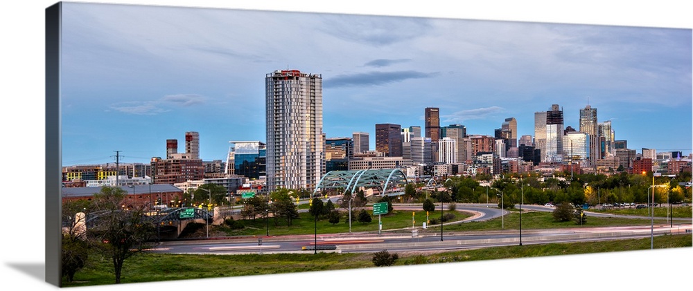 Photograph of the Denver, Colorado skyline with cloudy skies above.