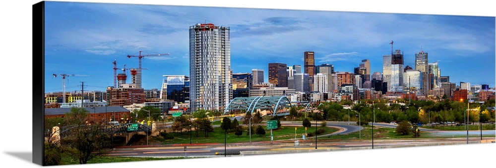 Photo of a Denver's skyline with light trails.