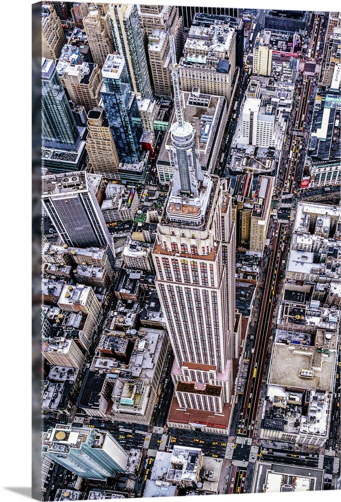 Aerial view of the Empire State Building surrounded by skyscrapers in New York City.