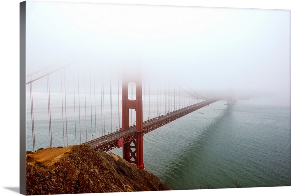 Landscape photograph of fog taking over the Golden Gate Bridge.