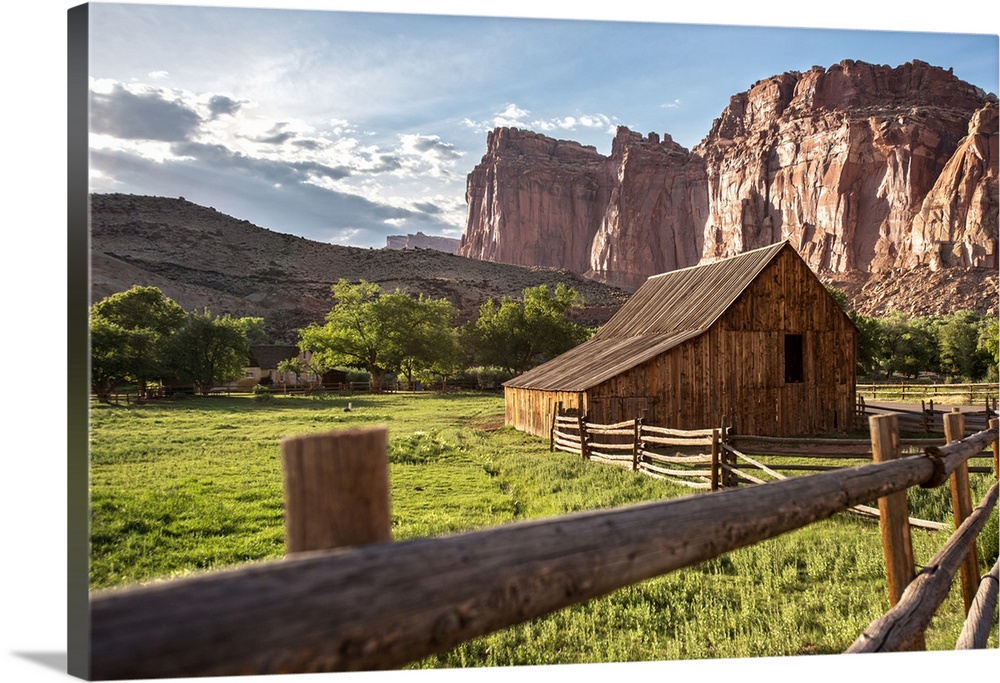 Gifford Homestead with the cliffs of the Waterpocket Fold overlooking it at Capitol Reef National Park in Utah.