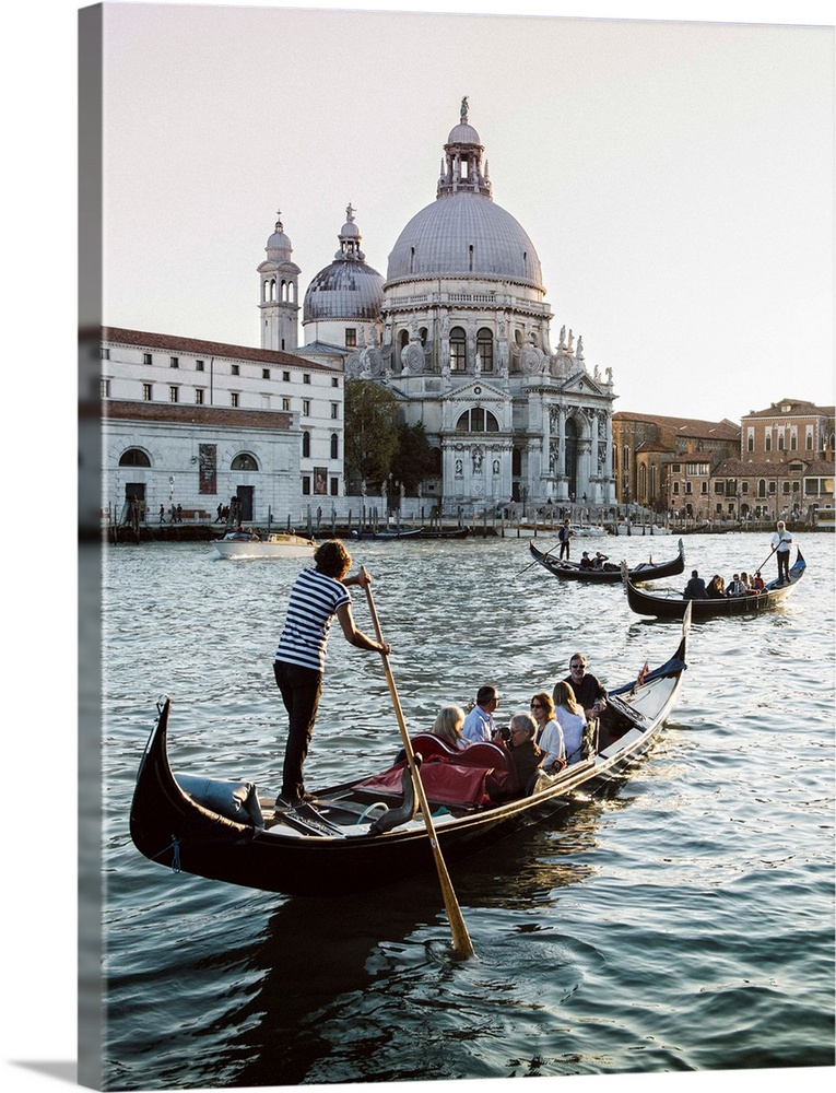 Photograph of gondolas rowing in front of Santa Maria della Salute in Venice.