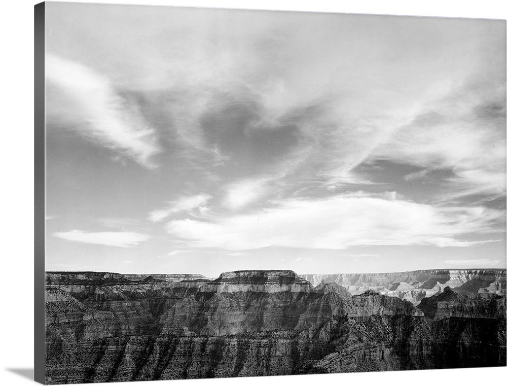 Grand Canyon National Park, canyon edge, low horizon, clouded sky.