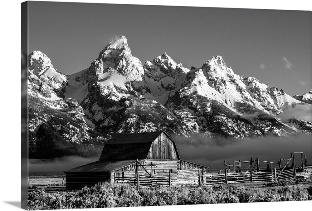 The John Moulton barn sits against a picturesque landscape of the Teton mountain range in Wyoming.