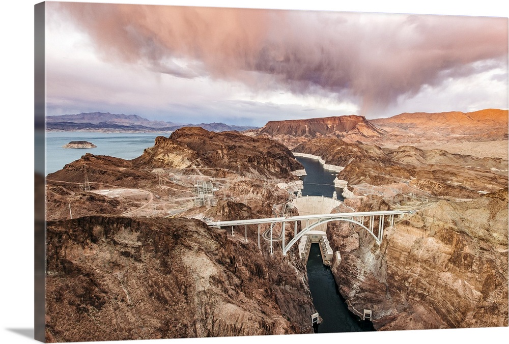 View from above of the Hoover Dam and Lake Mead, with the Mike O'Callaghan-Pat Tillman Memorial Bridge, at sunset with clo...