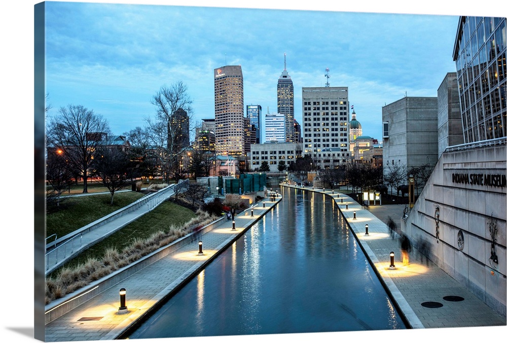 Photo of the Indianapolis city skyline reflecting onto the Indiana Central Canal.