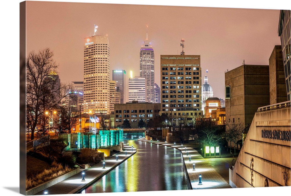 Photo of the Indianapolis city skyline at night reflecting onto the Indiana Central Canal.