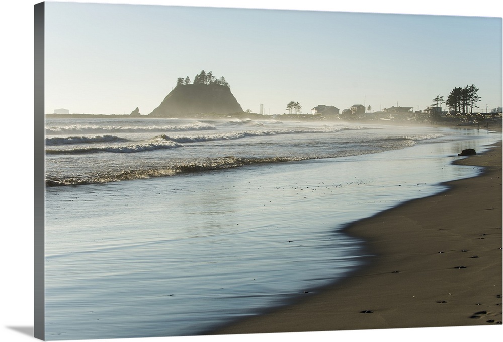 Landscape photograph of the La Push Beach shore with misty rock cliffs in the background.