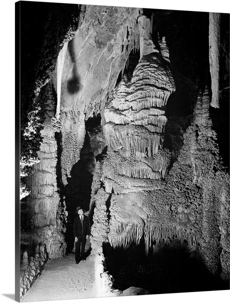 "Large Formation at the "Hall of Giantsin Carlsbad Cavern, path and rock formations, man on path.