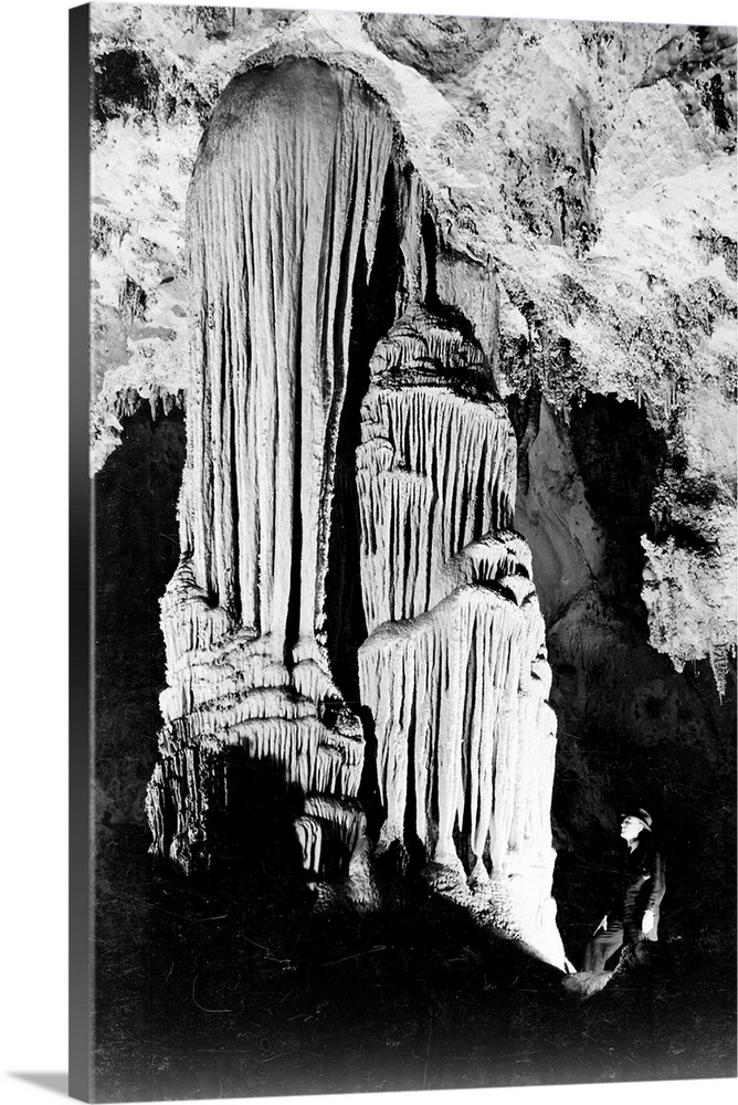 Large Stalactite Formation in the Kings Palace, illuminated stalactite, man on right.