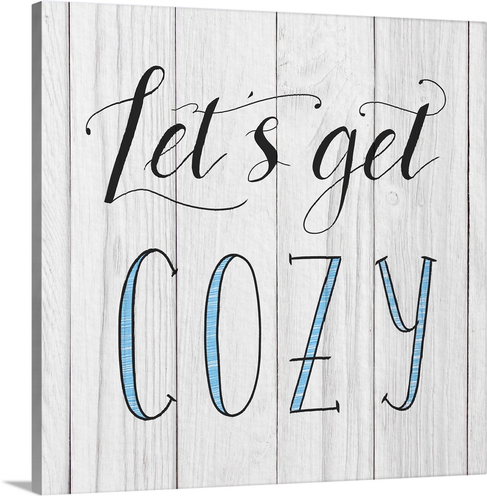 "Let's Get Cozy" handwritten in black and blue on a white wood panel background.