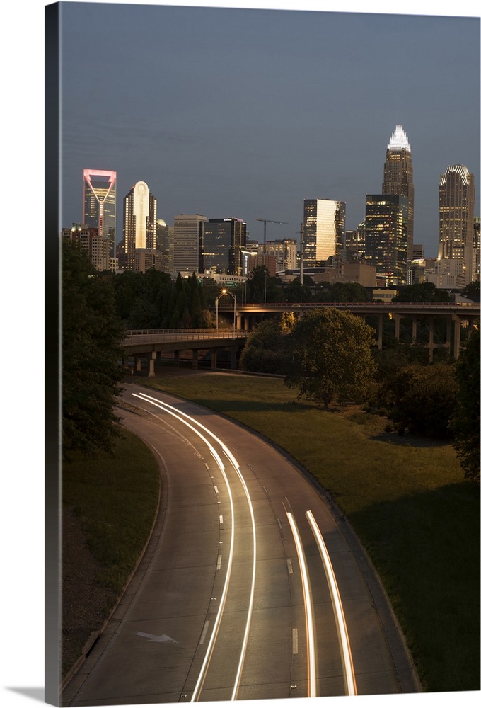 Light trails fill the foreground with Charlotte skyline in the background.
