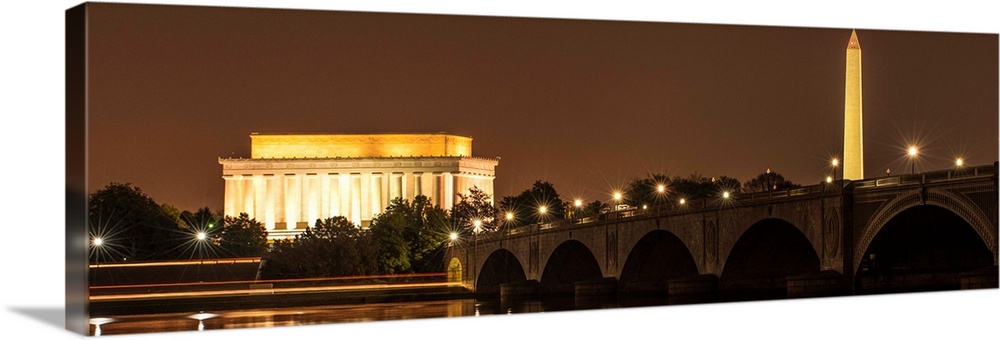 Panoramic photograph of the Lincoln Memorial and Washington Monument lit up at night in Washington, DC.