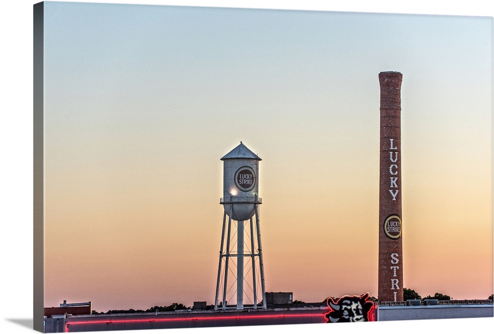 Lucky Strike Water Tower and Smokestack at sunset, over the neon Bull sign, American Tobacco Historic District, Durham, No...